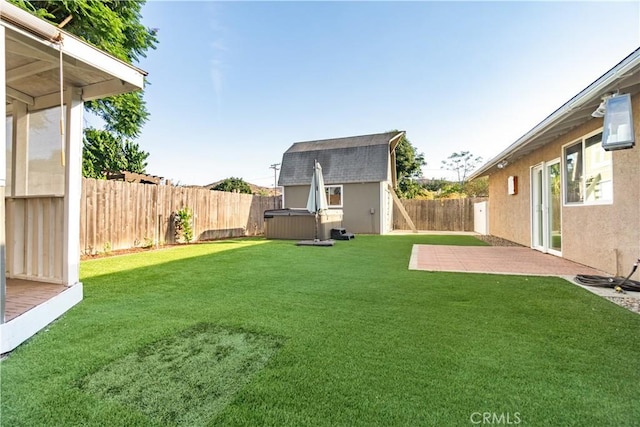 view of yard featuring a patio, a fenced backyard, a storage shed, an outdoor structure, and a hot tub