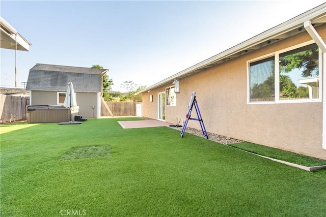 view of yard featuring a hot tub and a storage shed