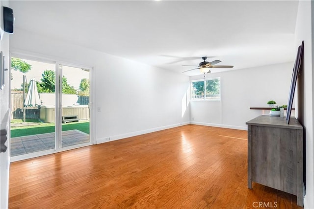 unfurnished living room featuring wood-type flooring and ceiling fan