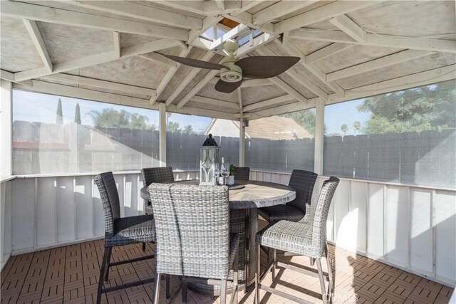 sunroom / solarium with vaulted ceiling with skylight and ceiling fan