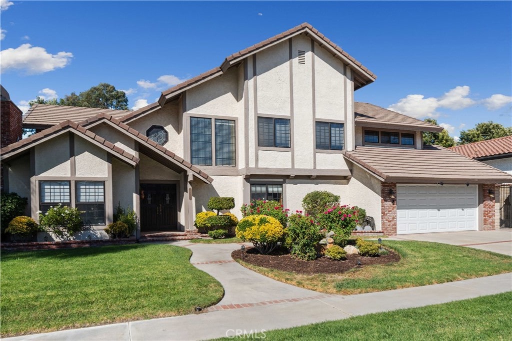 view of front of house featuring a garage and a front lawn