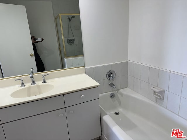 bathroom with vanity and a tub to relax in