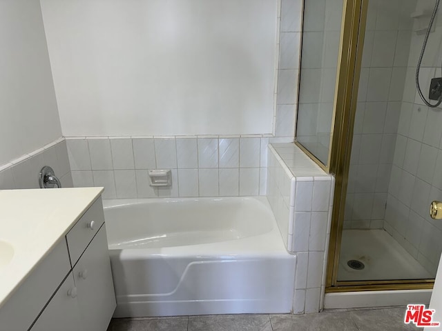 bathroom featuring tile patterned floors, vanity, and separate shower and tub