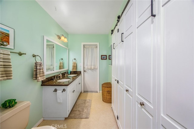 bathroom with toilet and vanity