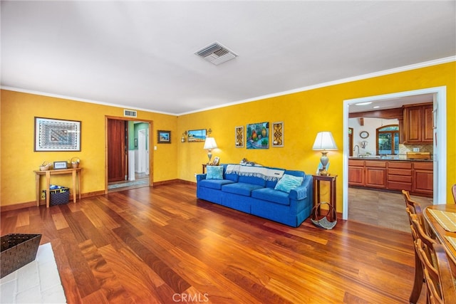 living room with ornamental molding and hardwood / wood-style flooring