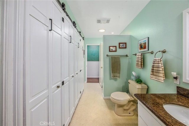 bathroom with toilet and vanity