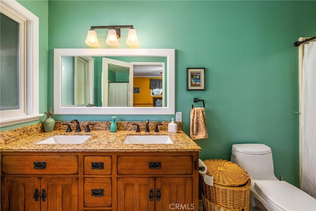 bathroom featuring vanity and toilet