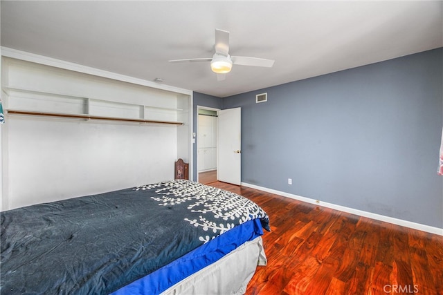 bedroom with a closet, hardwood / wood-style floors, and ceiling fan