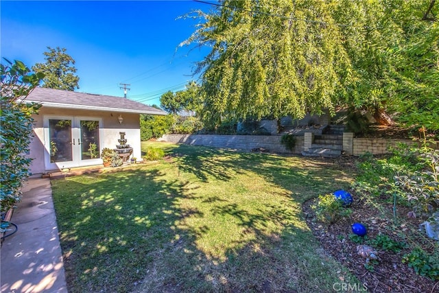 view of yard featuring french doors