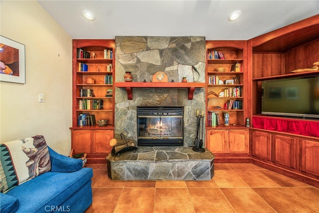 tiled living room with a fireplace and built in shelves