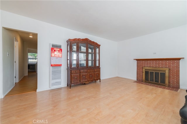 living room featuring light hardwood / wood-style floors and a fireplace