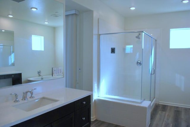 bathroom featuring hardwood / wood-style floors, vanity, and independent shower and bath