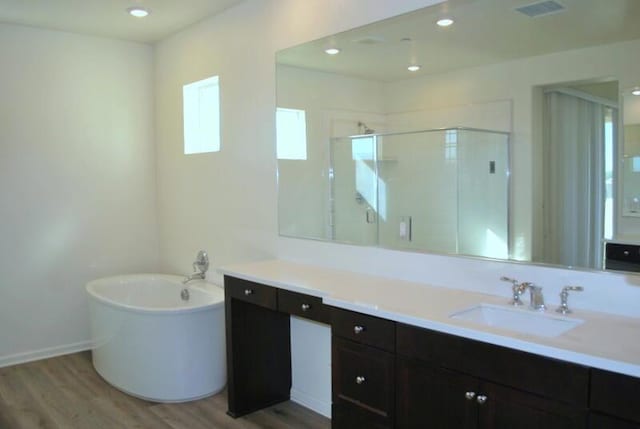 bathroom with separate shower and tub, hardwood / wood-style floors, and vanity