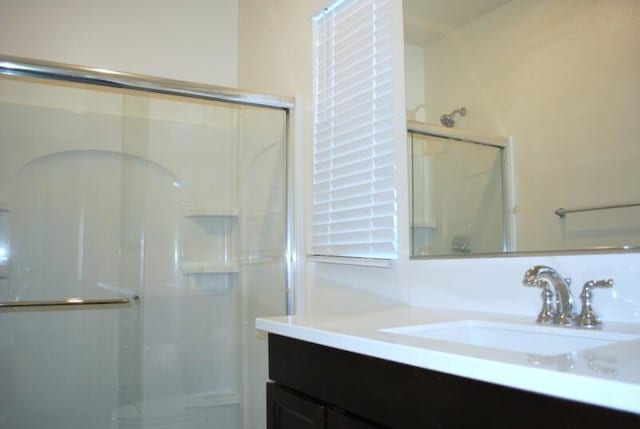 bathroom featuring vanity and an enclosed shower