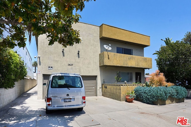 view of front of property with a balcony and a garage