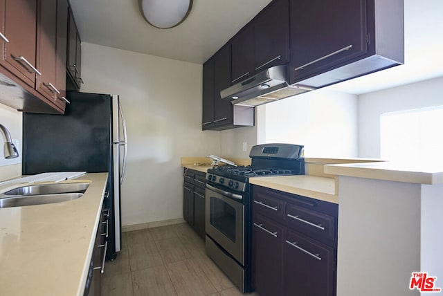 kitchen featuring stainless steel gas range oven and sink