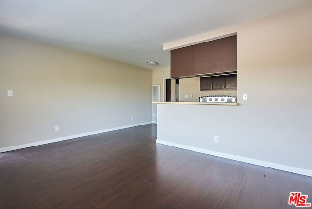 unfurnished living room featuring dark wood-type flooring