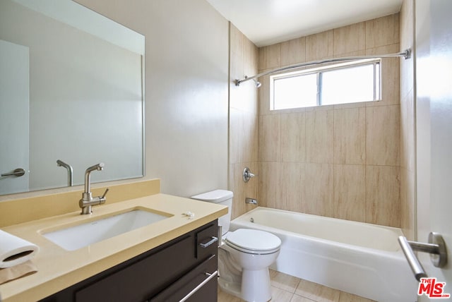 full bathroom with tiled shower / bath combo, tile patterned floors, vanity, and toilet