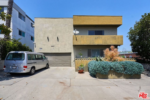 view of front of house with a balcony and a garage