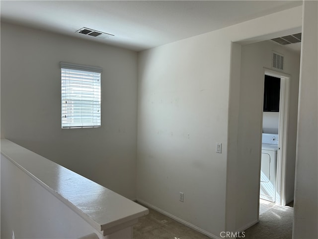 interior space with washer / clothes dryer and carpet floors