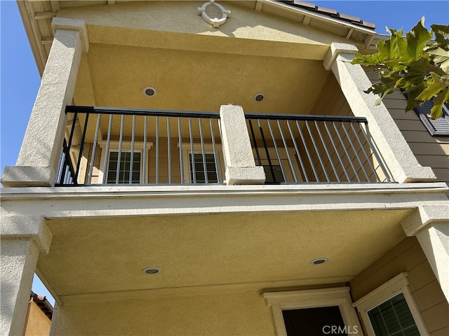 view of exterior entry featuring a balcony