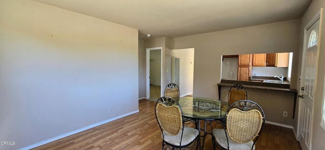 dining room with light hardwood / wood-style flooring and sink