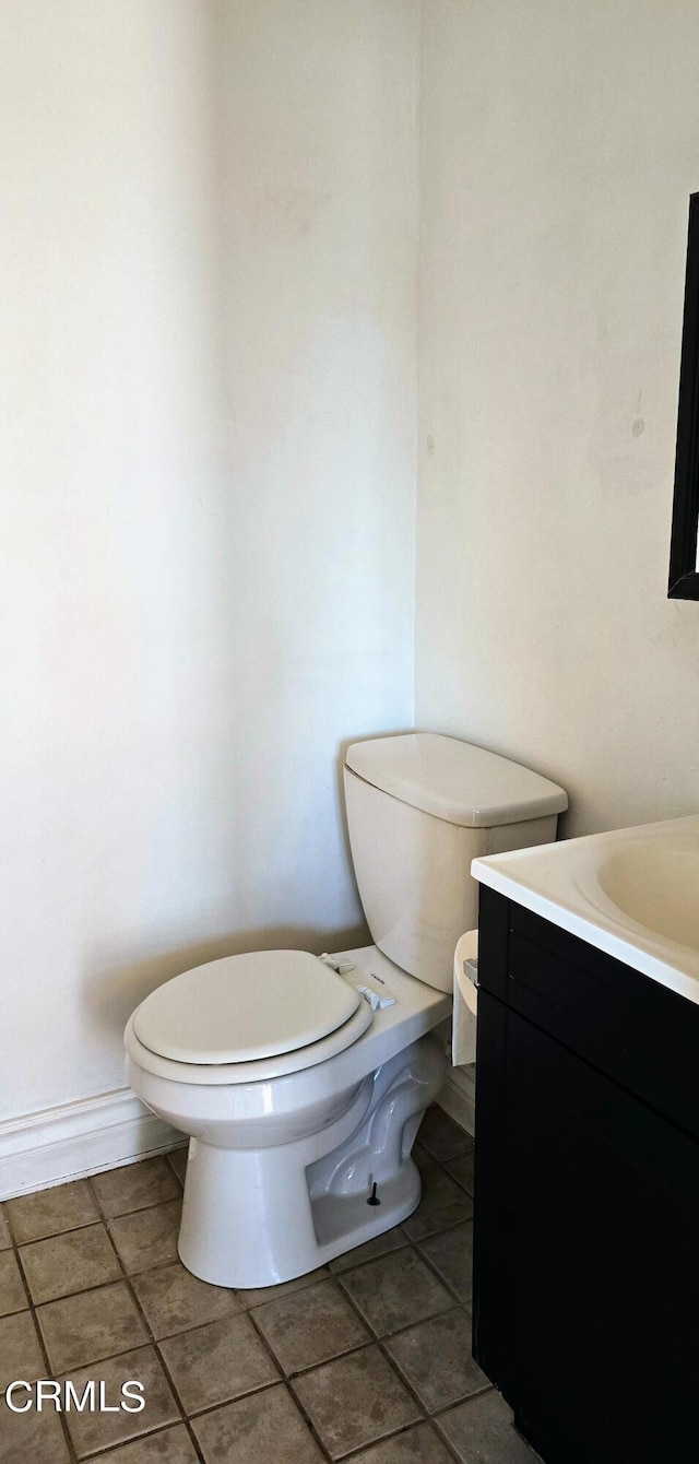 bathroom with tile patterned flooring, vanity, and toilet