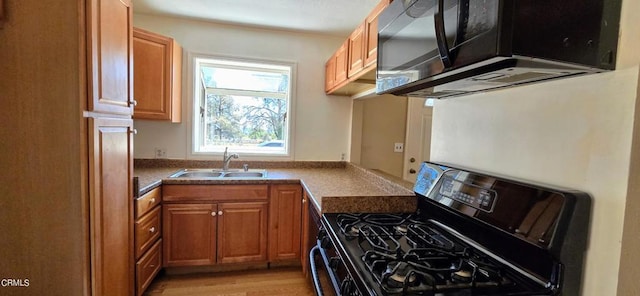 4112 Grant Trl, Frazier Park, CA 93225 - kitchen with stainless steel range with gas cooktop, brown cabinetry, light wood finished floors, and dark countertops