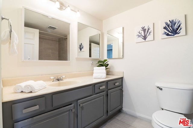 bathroom with tile patterned floors, vanity, and toilet