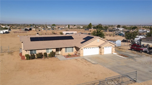 view of front of home with solar panels and a garage