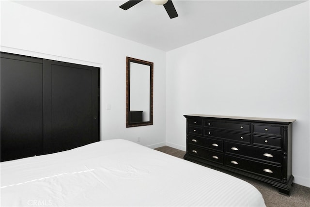 bedroom featuring ceiling fan, a closet, and dark colored carpet