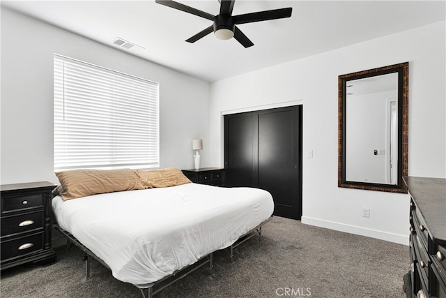 bedroom with ceiling fan, a closet, and dark carpet