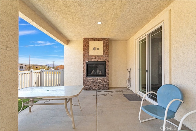 view of patio / terrace with an outdoor stone fireplace