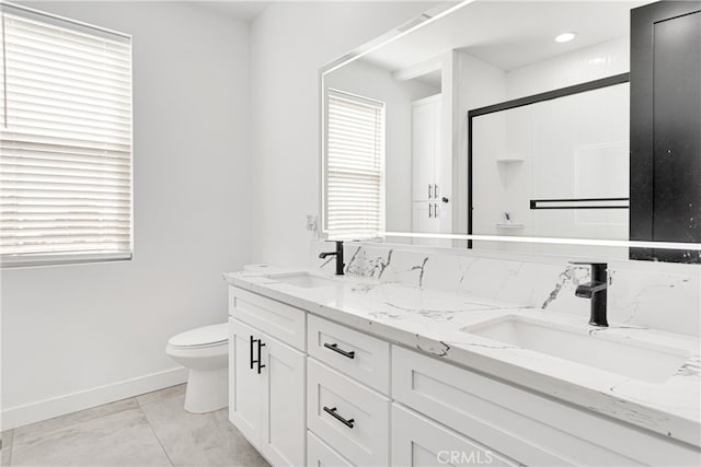 bathroom with a shower with door, tile patterned floors, vanity, and toilet