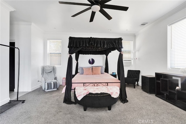 carpeted bedroom featuring ornamental molding and ceiling fan