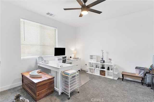 carpeted office space featuring ceiling fan