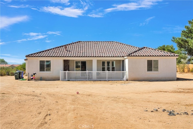 rear view of property featuring a porch