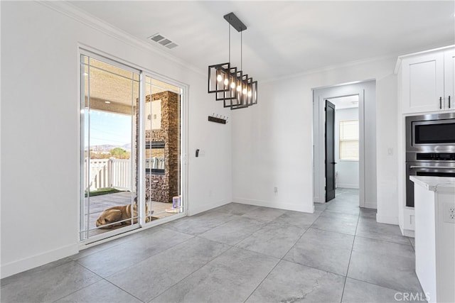 unfurnished dining area with crown molding and a chandelier