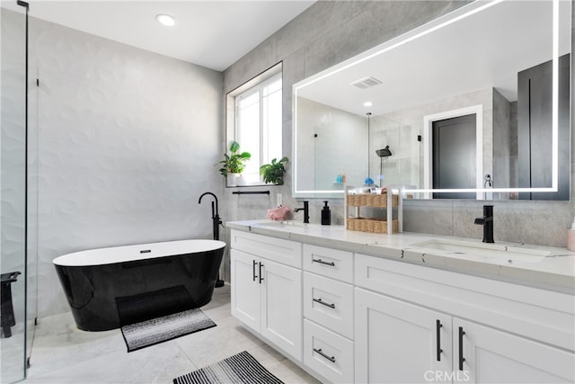 bathroom featuring tile patterned flooring, vanity, and independent shower and bath