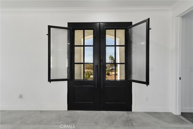 entryway featuring french doors and crown molding