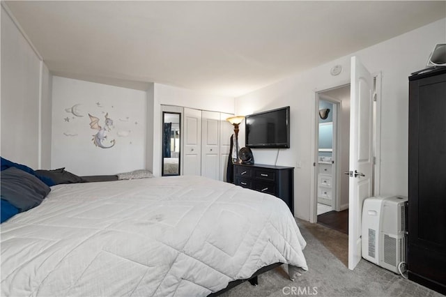 carpeted bedroom featuring heating unit and a closet