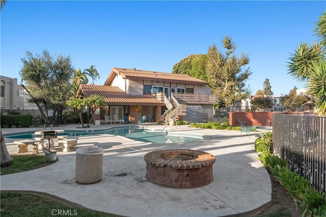 view of pool featuring a patio area and a fire pit