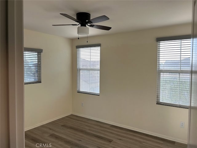 empty room featuring dark hardwood / wood-style floors and ceiling fan