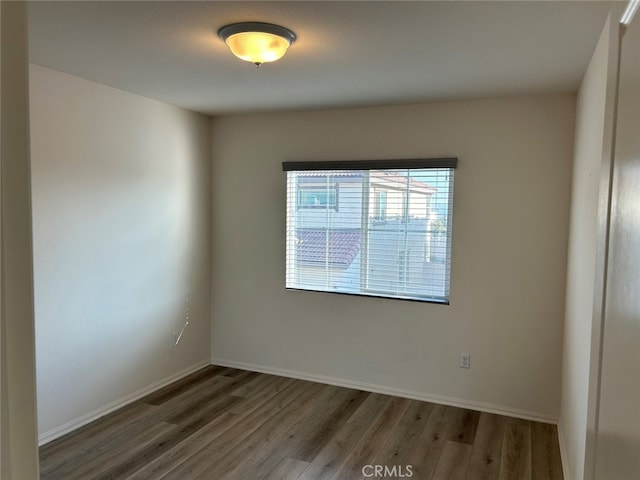 unfurnished room with dark wood-type flooring