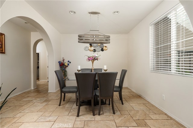 dining area featuring a notable chandelier