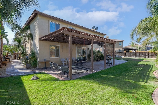 rear view of property featuring a pergola, a patio area, and a lawn