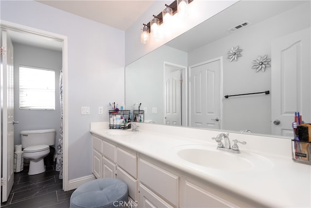 bathroom with vanity and toilet