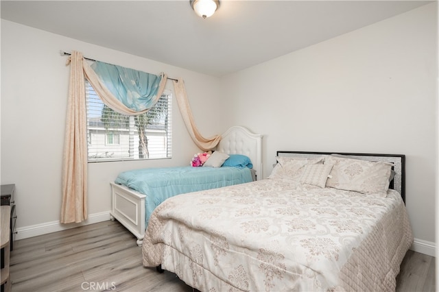 bedroom with hardwood / wood-style floors