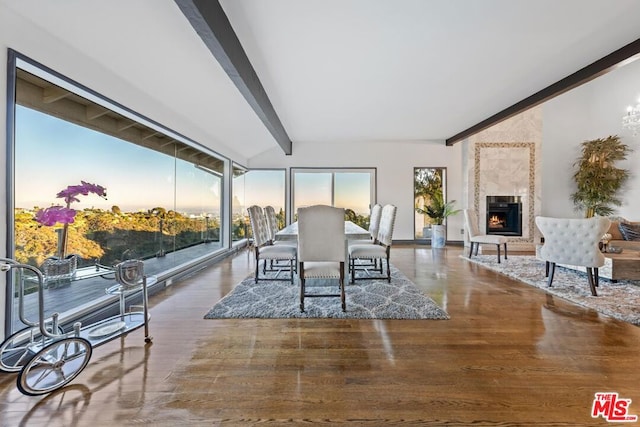 sunroom / solarium featuring beamed ceiling and a high end fireplace