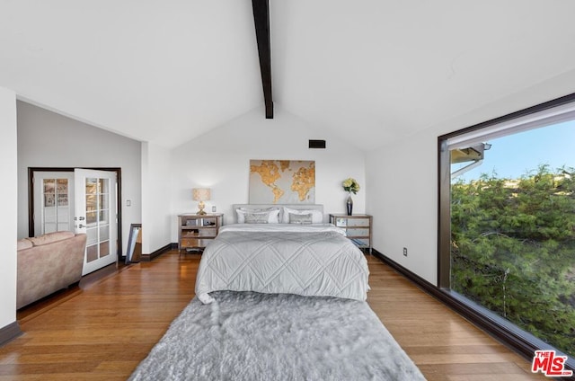 bedroom with french doors, vaulted ceiling with beams, hardwood / wood-style floors, and multiple windows